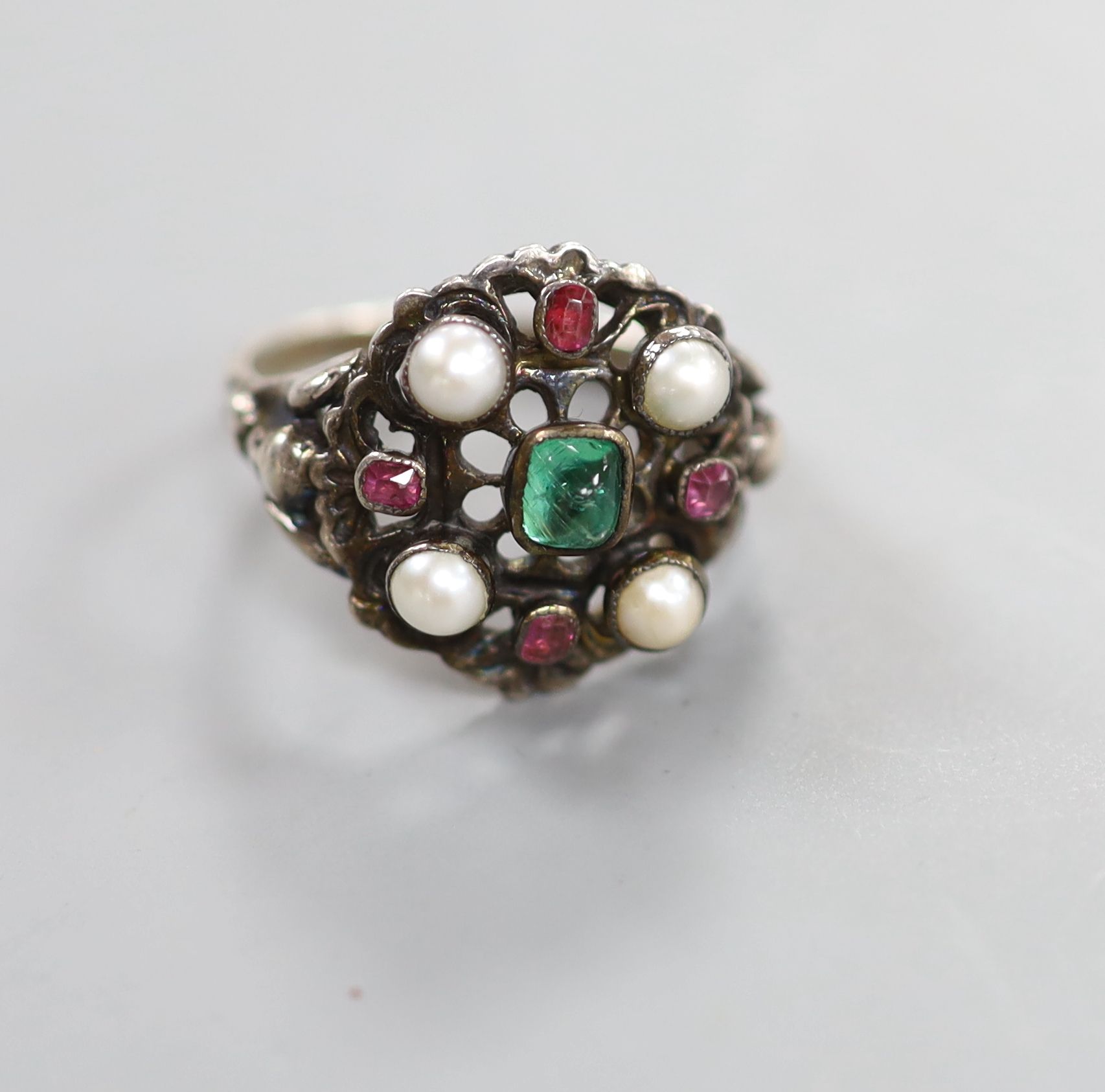 An Arts & Crafts white metal , gem and split pearl set cluster ring